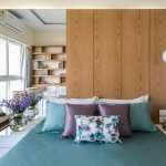 Custom floor-to-ceiling bedroom wardrobe with integrated storage lofts by Finelook Interior.